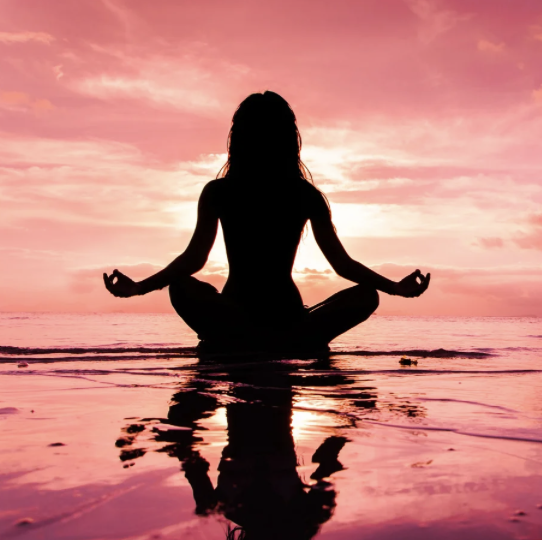 A person meditating, symbolizing tranquility and mindfulness.